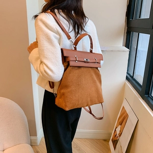 Detail of caramel brown PU and suede backpack featuring classic twist lock and top handle