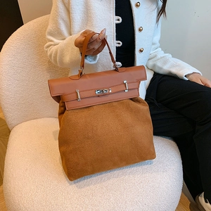 Detail of caramel suede and leather texture on a large capacity vintage tote bag
