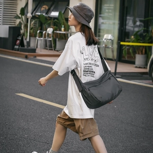 Deep grey nylon messenger bag with front zip pocket for street leisure and daily commute