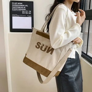 Canvas tote bag detail showing large capacity and adjustable fabric shoulder strap