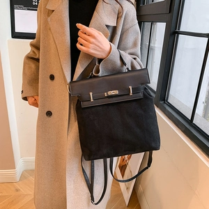 Minimalist black PU and faux suede handbag with metallic twist lock and slim shoulder strap