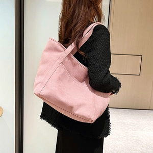 Minimalist pink large capacity tote bag in textured material with wide shoulder strap for women
