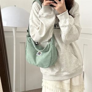 Minimalist sage green corduroy crossbody bag with a cute bear patch and striped texture