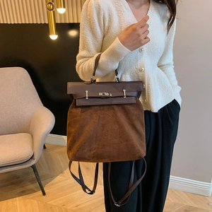Vintage brown suede and leather handbag for women featuring a stylish metal buckle strap