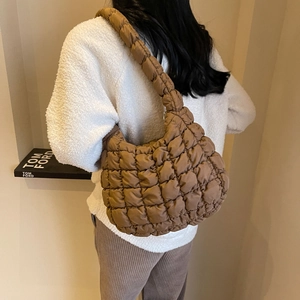 Détail du sac à bandoulière matelassé marron avec une texture rembourrée de luxe