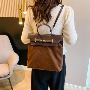 Detail of caramel suede and dark brown leather拼接 handbag worn by model from back