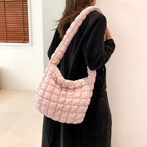 Detailed back view of pink quilted padded shoulder bag showing drape and texture