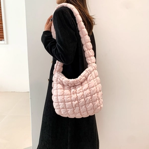 Pink quilted crossbody puffer bag with cloud texture and padded strap for women