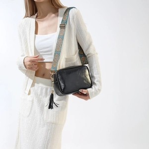 Sac bandoulière chic en simili cuir noir avec large sangle bohème colorée et décor de glands