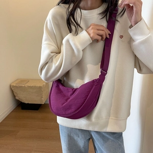 Minimalist purple nylon half moon crossbody bag with adjustable wide fabric strap
