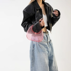 Chic pink acrylic handbag with bubble texture paired with leather jacket and denim