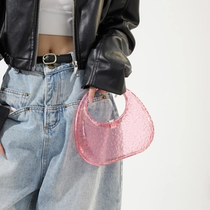 Detail of pink translucent acrylic moon bag with bubble texture and metal buckle