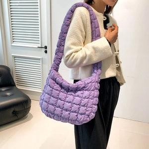 Macro shot of the purple quilted bubble shoulder bag showing padded rhombic texture detail