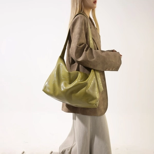 Detail of soft pleated olive green pu leather tote bag with wide shoulder strap