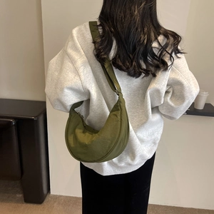 Detail of olive green crescent hobo bag made of lightweight nylon with adjustable strap
