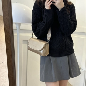 Champagne gold PU crossbody bag with patterned wide strap worn over a knit sweater