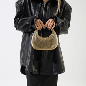 Detail of amber acrylic handbag featuring unique embossed circular bubble texture
