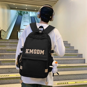 Minimalist black nylon backpack with KMGDM embroidery and cute duck plush charm