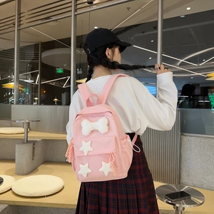 Pink nylon backpack with plush bone and stars decorations in a cute Japanese style