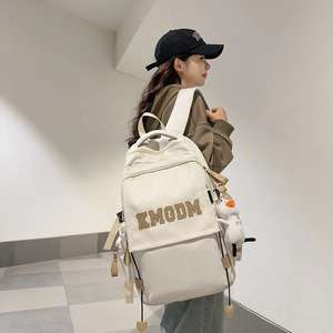 Minimalist white nylon backpack with KMODM letter patch and cute duck charm
