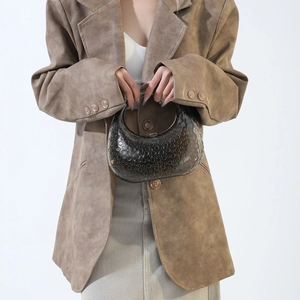 Fashionable translucent dark acrylic handbag with bubble texture shown with a model