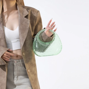 Macro detail of a light green acrylic handbag with unique bubble dot texture