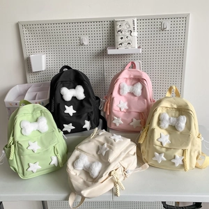 Collection of colorful nylon backpacks with plush bone and star patches for daily use