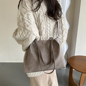Detail of terracotta PU leather tote bag with stylish patterned wide shoulder strap