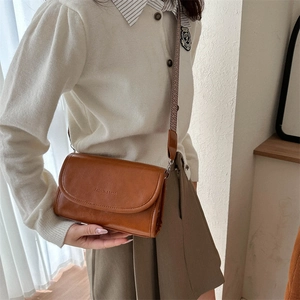 Brown retro PU leather crossbody bag featuring Fashion & Bags logo and wide strap
