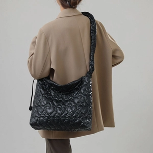 Detail view of heart-shaped quilted pattern on high-end black nylon shoulder bag