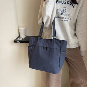 Minimalist navy blue canvas tote bag with large capacity for daily commuting