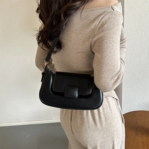 Chic black PU leather shoulder bag with square buckle flap shown on model side view