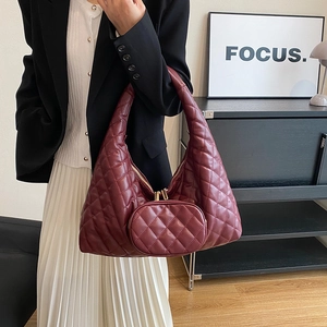 Detail of burgundy quilted hobo bag with matching detachable coin purse and gold hardware