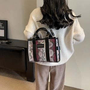 Women's chic snake print tote bag in red and grey with adjustable crossbody strap
