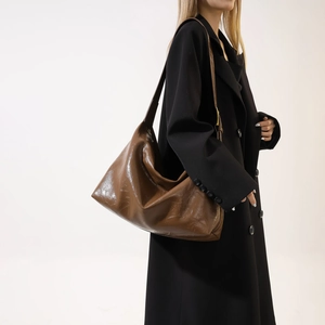 Detailed view of large brown PU leather hobo bag with high-gloss finish and soft texture