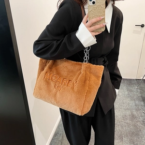 Close-up of the plush brown tote bag with MOAREY ITALY embroidery and silver metal chain