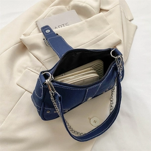 Navy blue denim underarm bag with silver chain strap and white contrast stitching detail