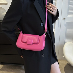 Detailed view of magenta PU leather crossbody bag featuring gold hardware and flap closure