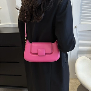 Detailed view of rose pink half-moon crossbody bag in premium textured vegan leather