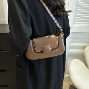 Minimalist brown PU leather baguette bag with flap closure shown on model