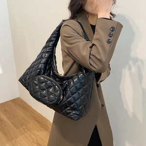 Close-up of a black quilted hobo bag with PU material and gold zipper detail