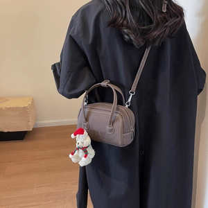 Minimalist caramel PU leather crossbody bag for women with cute bear charm and shoulder strap