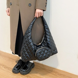 Detail of black quilted PU leather crossbody bag with matching mini round pouch accessory