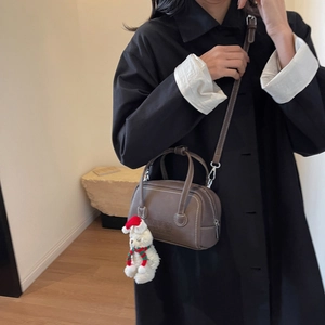 Dark brown retro Boston bag with round handles, adjustable strap and white rabbit pendant