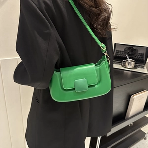 Side view of vibrant green PU leather shoulder bag with square buckle and adjustable strap