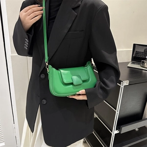 Detail shot of bright green PU leather crossbody bag featuring a square decorative buckle