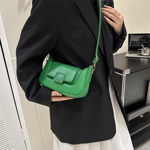 Close-up of green PU leather crossbody bag featuring unique pleated design and square buckle