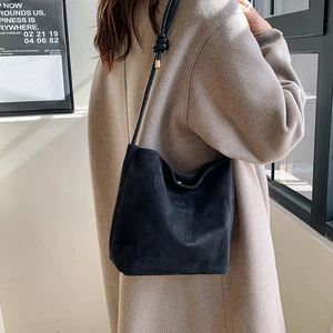 Black suede tote bag detail with onwards and upwards slogan and knotted shoulder strap
