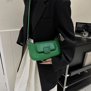 Detail view of the bright green PU leather crossbody bag with square decorative buckle