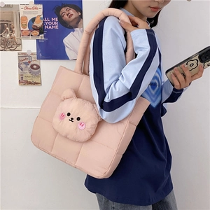 Detailed view of pink quilted nylon shoulder bag with a 3D plush bear on pink strap